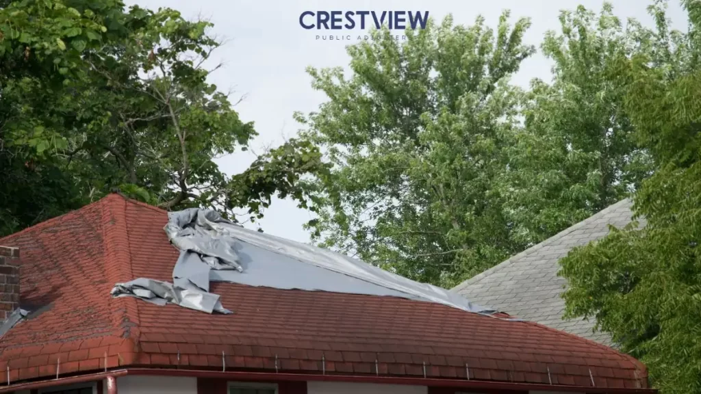 roof-storm-damage-with-tarp-covered-shingles